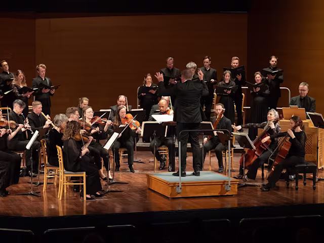 JS Bach: Mass in B Minor baroque musicians from the armonico consort on a concert stage wearing all black