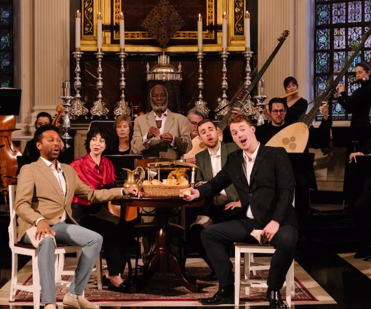 Bach's Markus Passion (Scottish Premiere) singers and historical instrumentalists sit around a table performing in a church