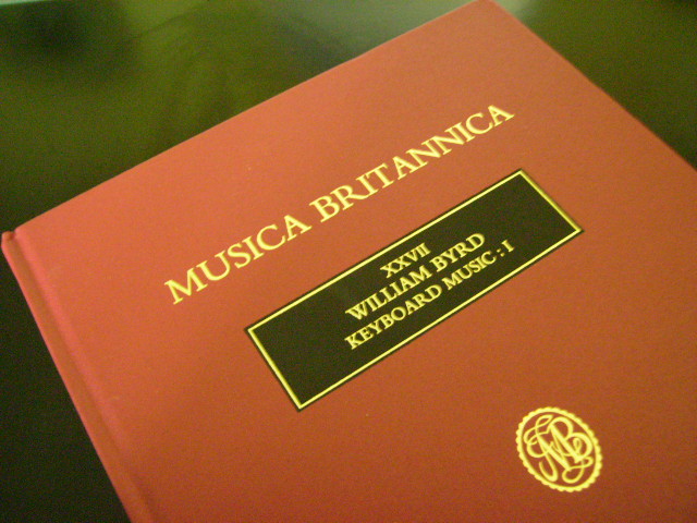 a hardback volume of keyboard music with a red colour and gold writing