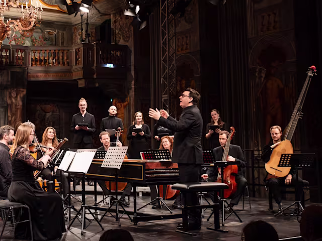 Handel's Lovers: A Recital of Operatic Arias & Duets baroque ensemble in a church with conductor waving his arms from the harpsichord