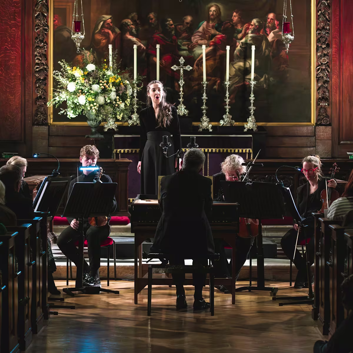 International Handel Singing Competition opens for entries a woman sings baroque music in an ornate church setting with a small orchestra in front of her
