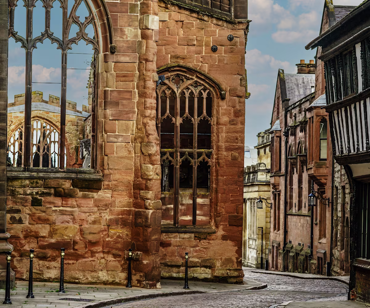 Echoes of Medieval Coventry a cobbled street twists past the ruins of coventry cathedral