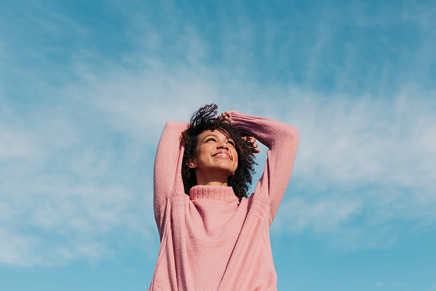 Femme regardant le ciel en souriant