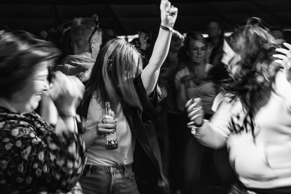 A black and white image of women dancing. 