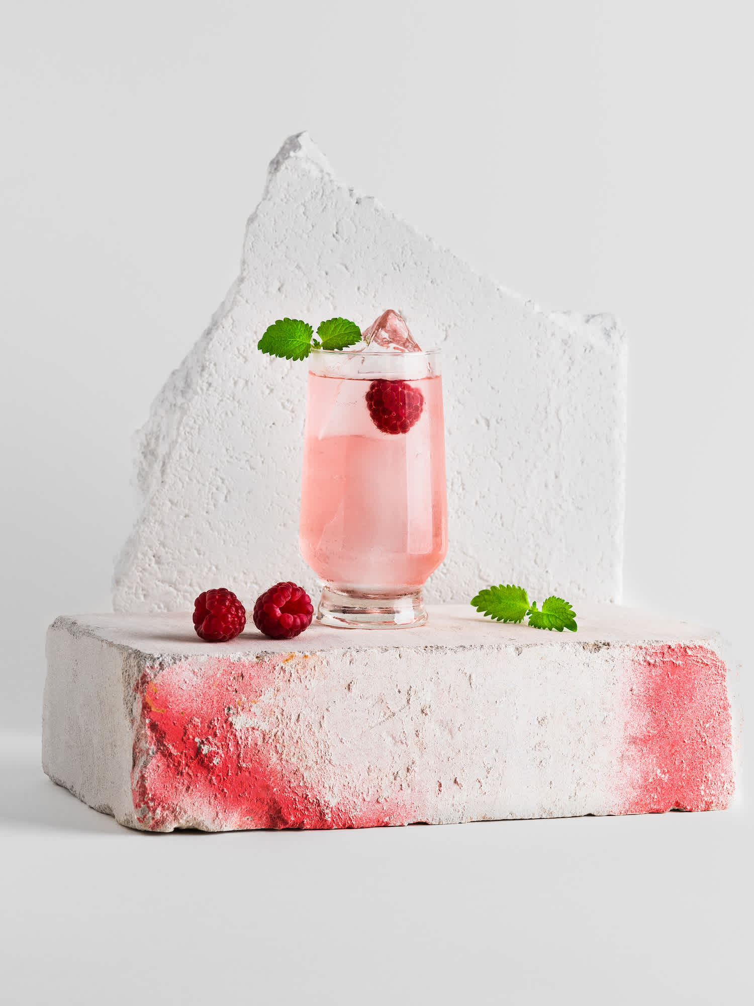 Pink cocktail made using Kyrö Kinobi Gin, tonic water and fresh raspberries.