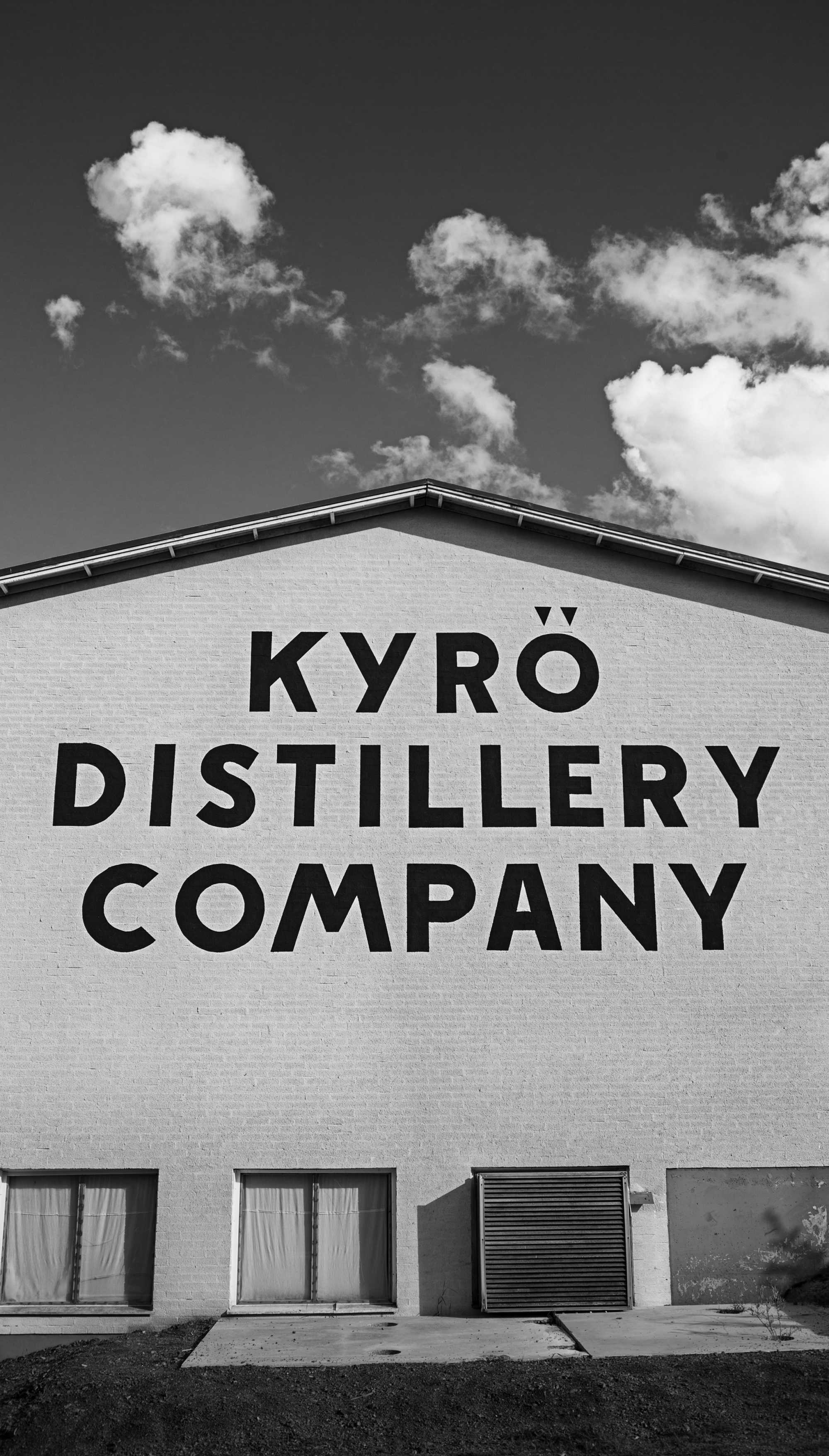 Black and white image of the Kyrö Distillery Company logo painted on to the production site. 