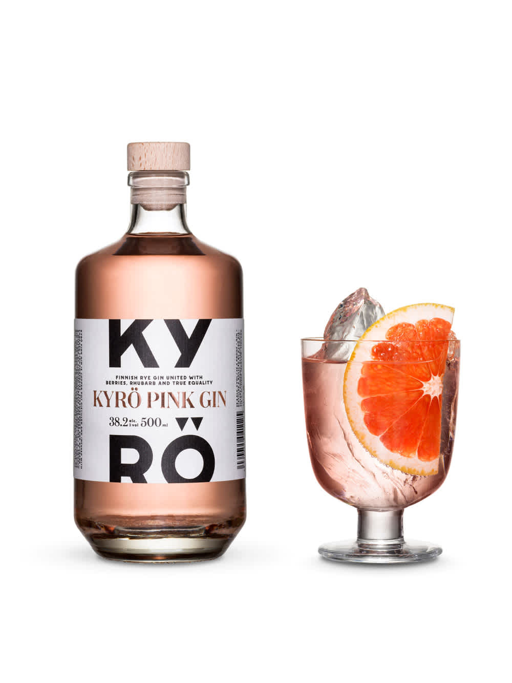 A bottle of Kyrö Pink Gin next to the perfect serve, in an Iittala cocktail glass, hand-cut shards of ice, and a slice of blood orange. Photo by KoskiSyväri.