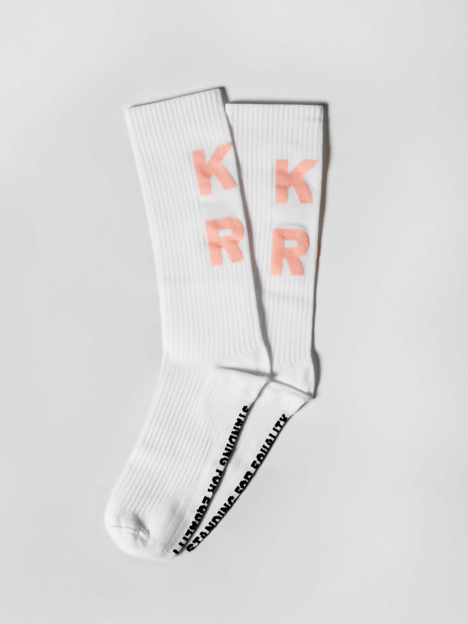 Product photo: white socks with pink Kyrö letters spelled out. 