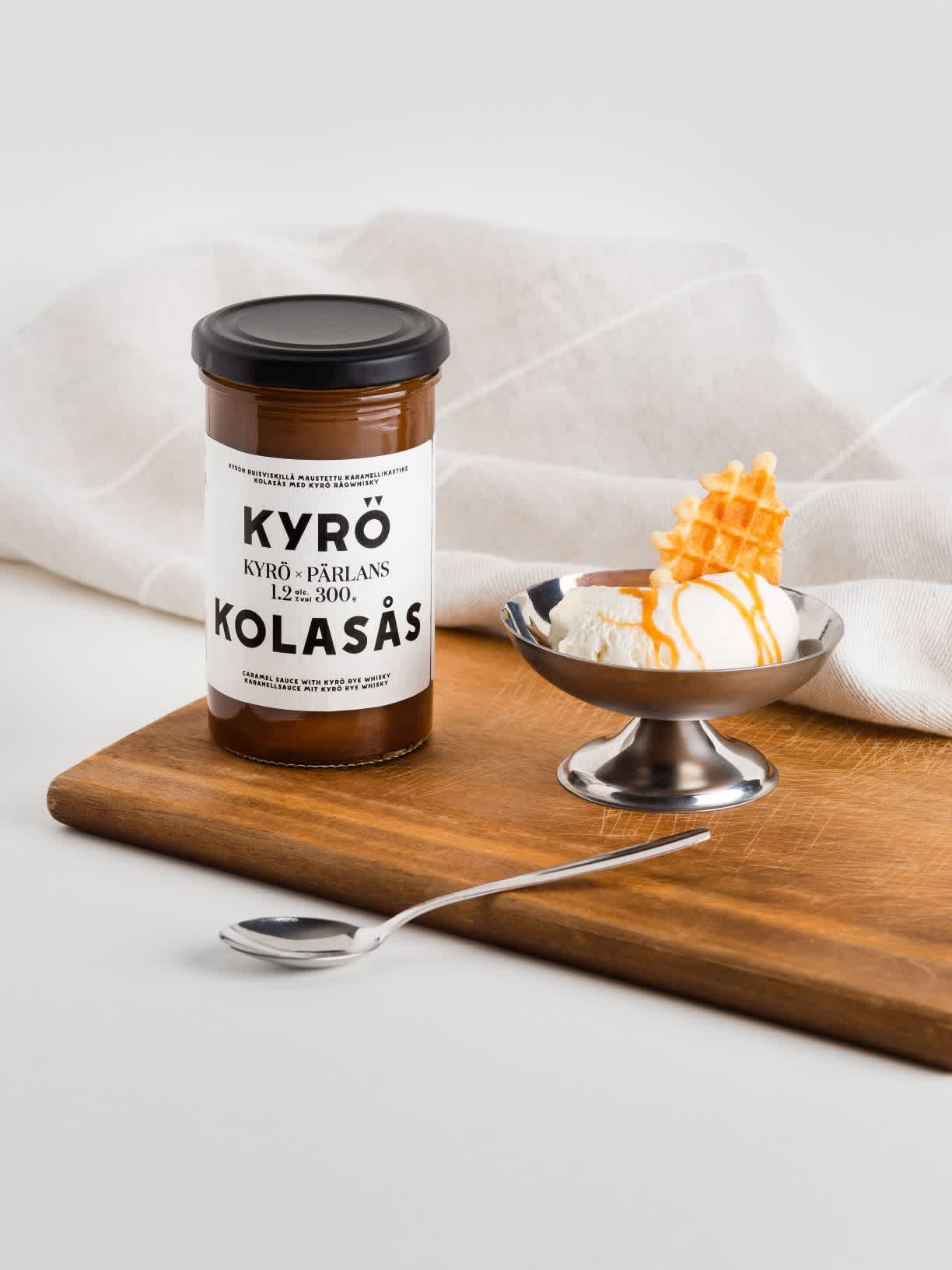 Kyrö x Pärlans caramel sauce jar placed next to vanilla ice cream in a bowl. Served with caramel sauce, of course.