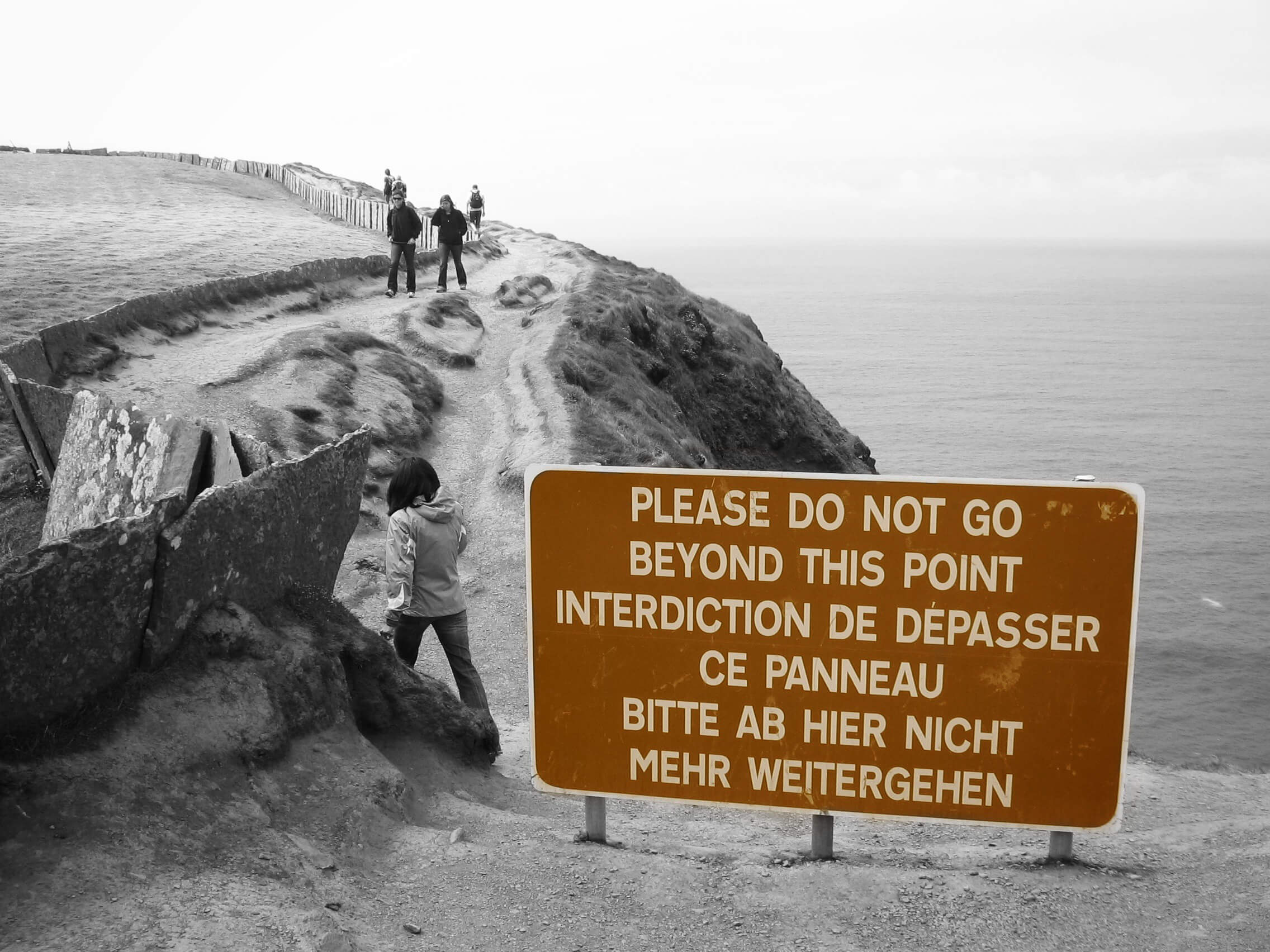 Sign reads "Please do not go beyond this point" at Cliffs of Moher