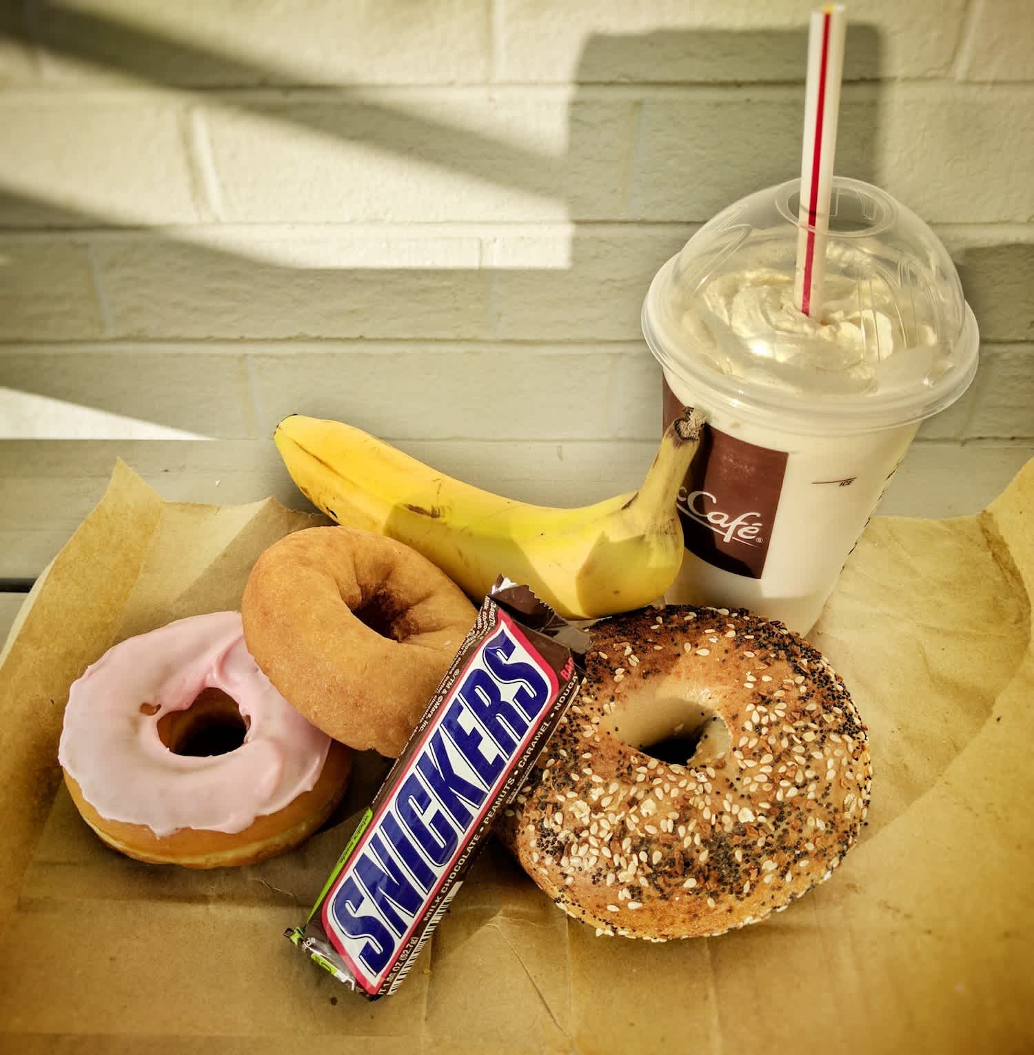 Fun facts about the above foods: (1) The banana has the “lowest calories,” but the Snickers bar is in 2nd place; the medium milkshake is the most calorically dense, tied with the donuts (2) The back of the Snickers bar boldy says, “SATISFIES” — now, why would they say that?