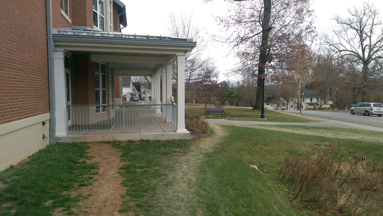 Worn footpaths in grass approaching a school