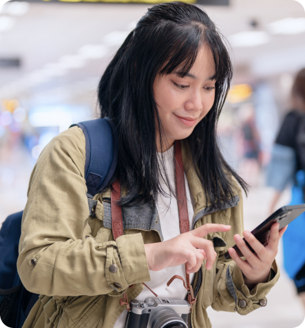 Travel - Woman checking phone in an airport