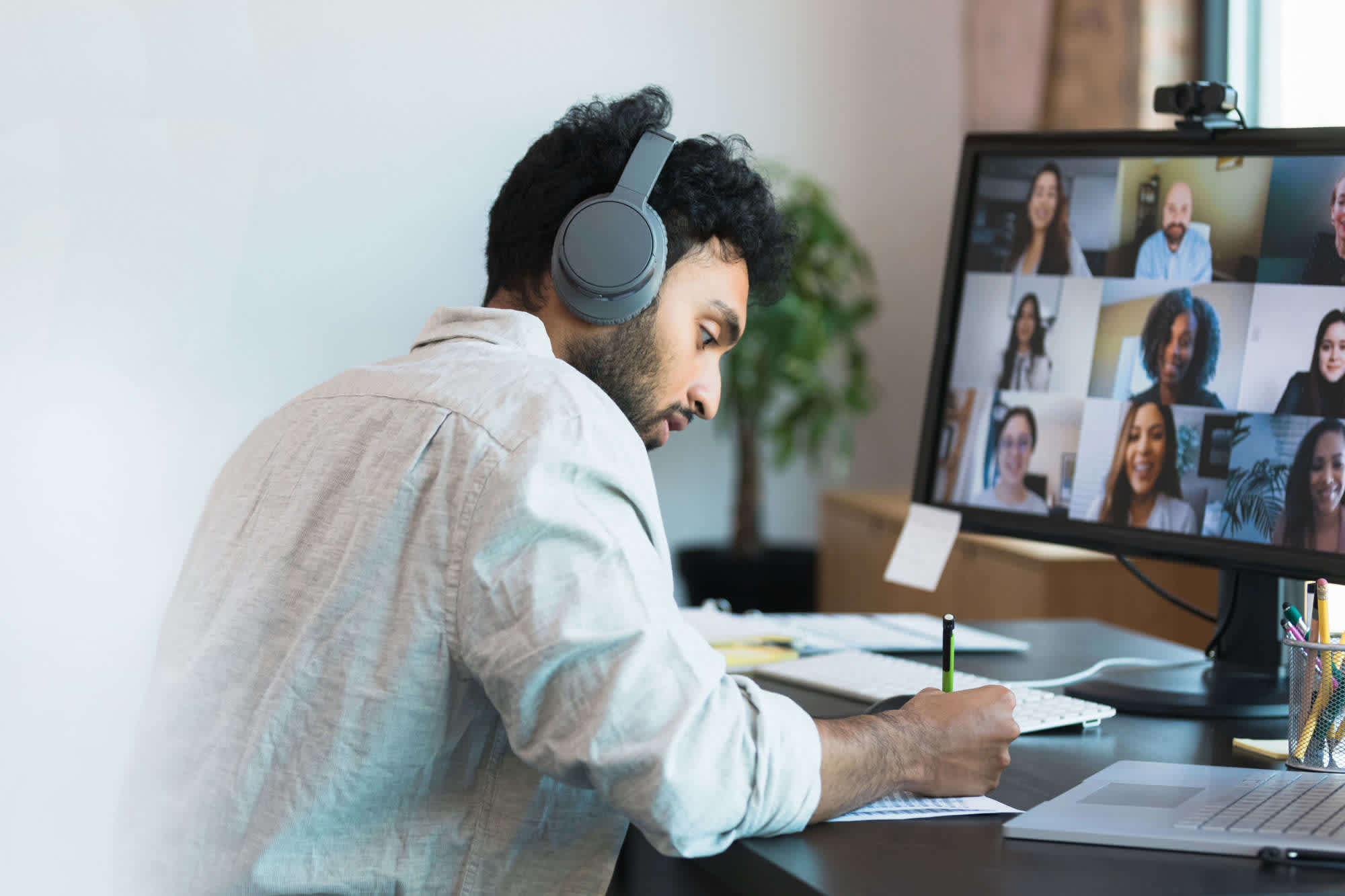 A man attends a remote meeting with his marketing team