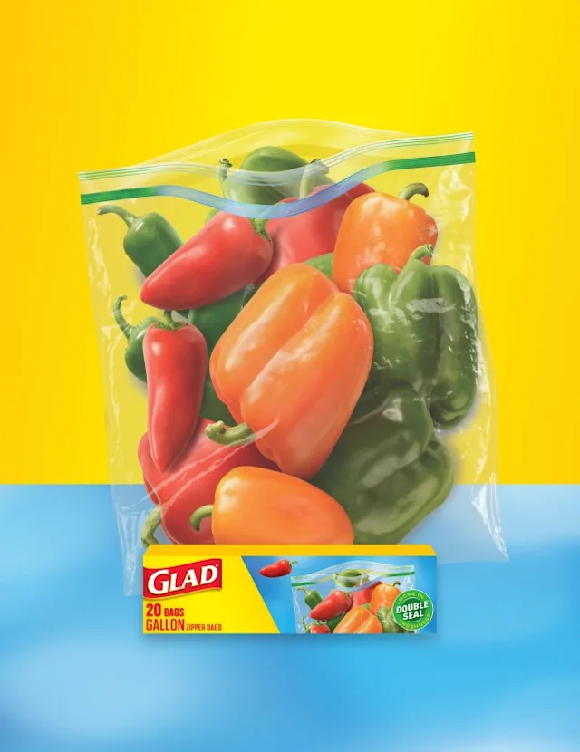 Bag of peppers on yellow and blue background, package of Glad food bags in front.