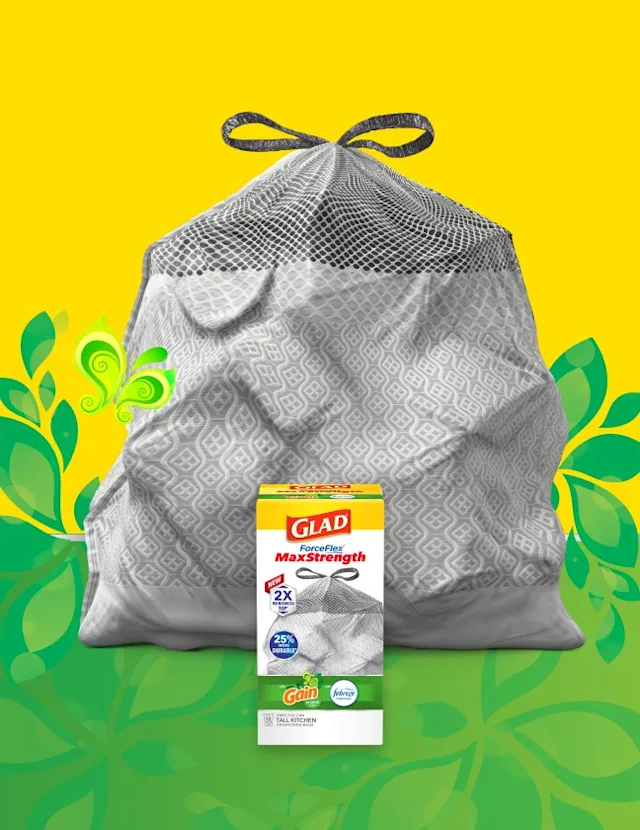 Gray bag on yellow and green background with green leaf, grass and butterfly illustrations, a box of Glad bags in front.