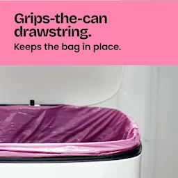 A pink trash bag in a trash can showing the grip strength of the bag. The words "Grips-the-can drawstring. Keeps the bag in place." on a pink background above.