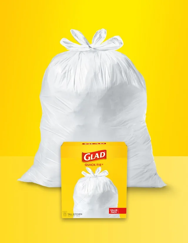 White trash bag on yellow background with Glad trash bag package in front