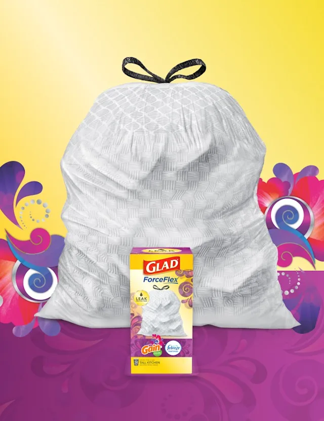 White trashbag with black handles on a yellow and purple background with dark purple and pink swirls, A box of Glad trash bags is in front.