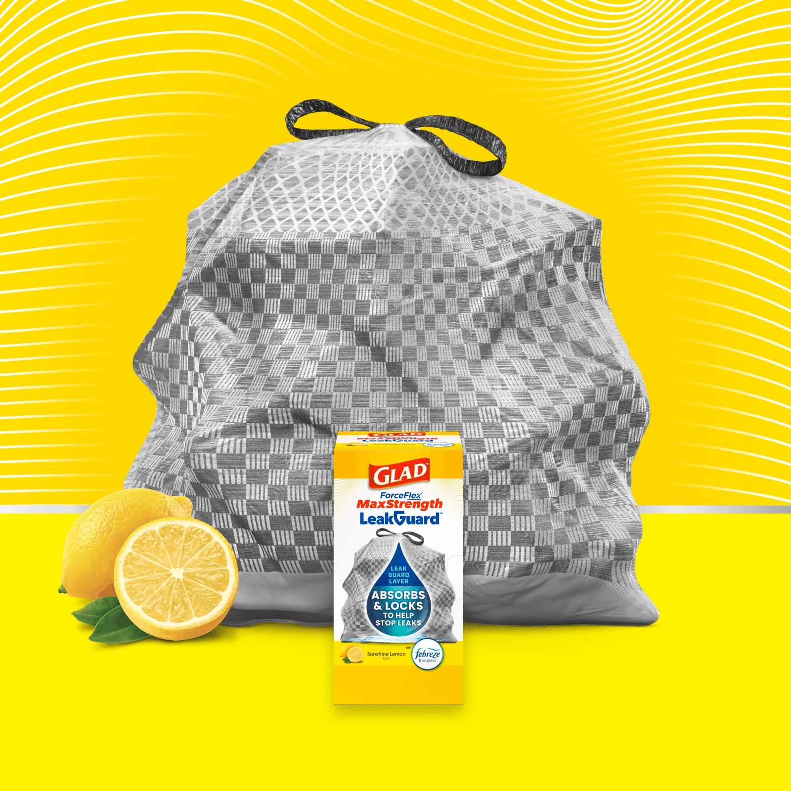 A package of Glad ForceFlex MaxStrength LeakGuard Sunshine Lemon trash bags in front of a gray bag on a yellow background
