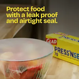 A glass bowl of food with Press'n Seal over the top. The words "Protect food with a leakproof and airtight seal"
