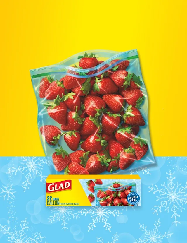 Bag of strawberries, box of Glad food bags, on a yellow and blue background.