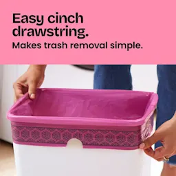 Hands putting a bag in a small trash can. A pink panel with the words "Easy cinch drawstring. Makes trash removal simple."