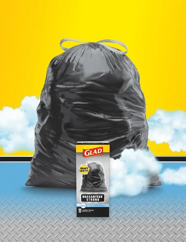 Glad heavy-duty garbage bag with a box of Glad guaranteed strong trash bags on a yellow and blue background.