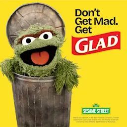 The Muppet Oscar the Grouch in a trash can with the words Don't Get Mad. Get Glad and a Sesame Street logo on a yellow background