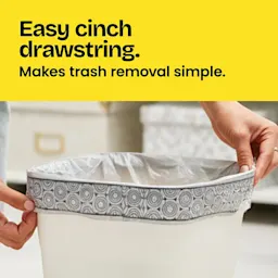Hands putting a bag in a small trash can. A blue panel with the words "Easy cinch drawstring. Makes trash removal simple."