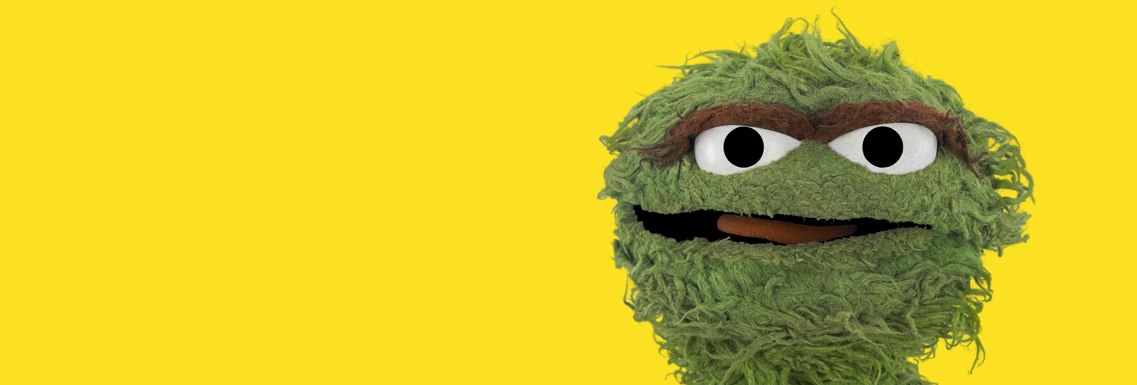 Oscar the Grouch on a yellow background