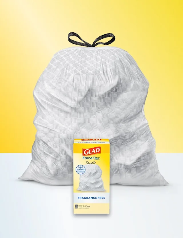 Glad ForceFlex Fragrance Free tall kitchen trash bag with a black drawstring, shown in front of its packaging box on a yellow background.