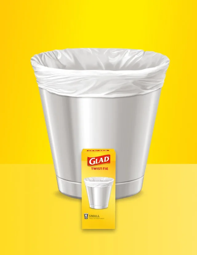 Small metal trash can with white bag inside on a two-tone yellow background with package of Glad trash bags in front.