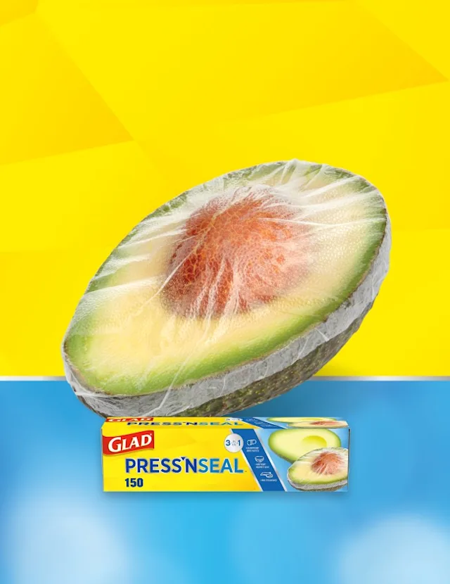 Avocado wrapped in Press'N Seal. Yellow and blue background. Press'N Seal box in front.