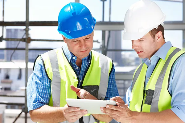 Two construction executives looking at an iPad THUMBImage