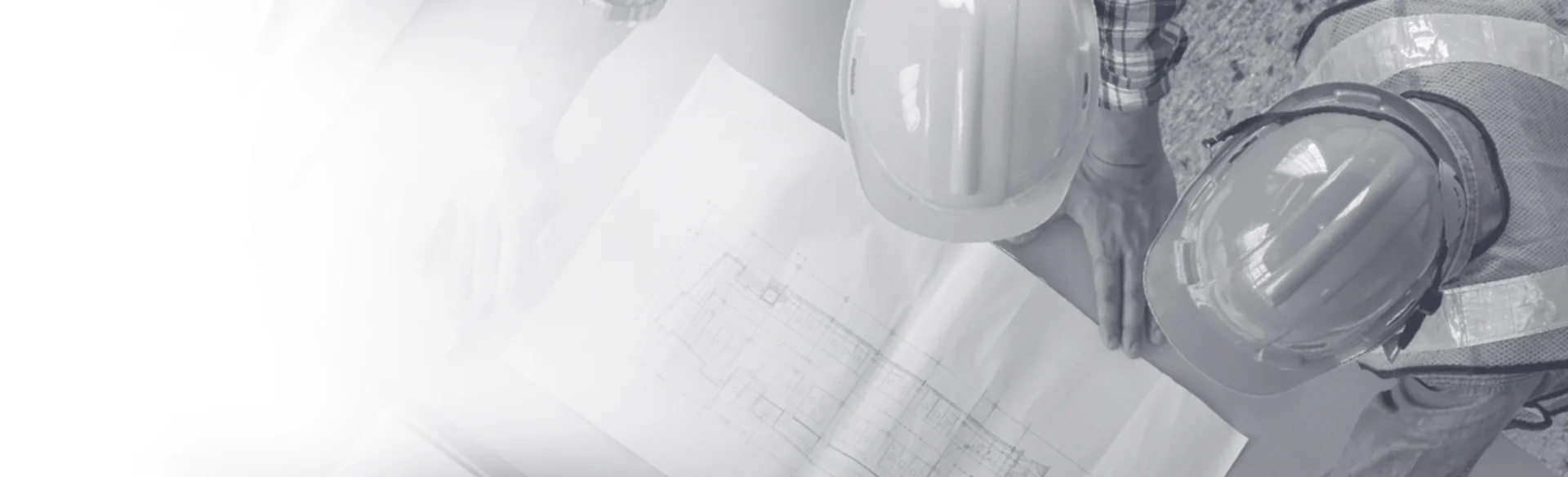 Over head shot of two construction workers looking at a drawing