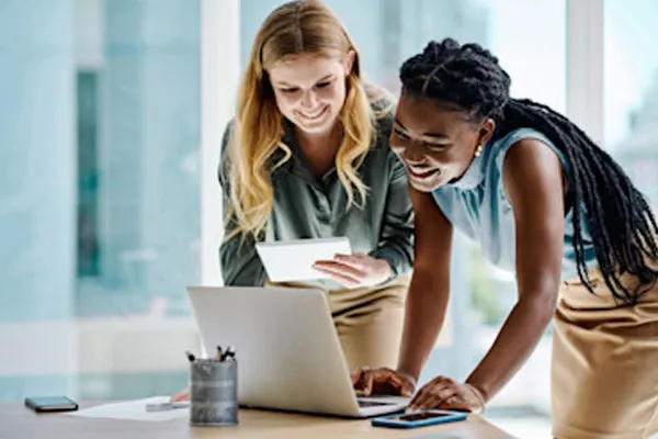 Two females looking at a laptop - THUMBNAIL