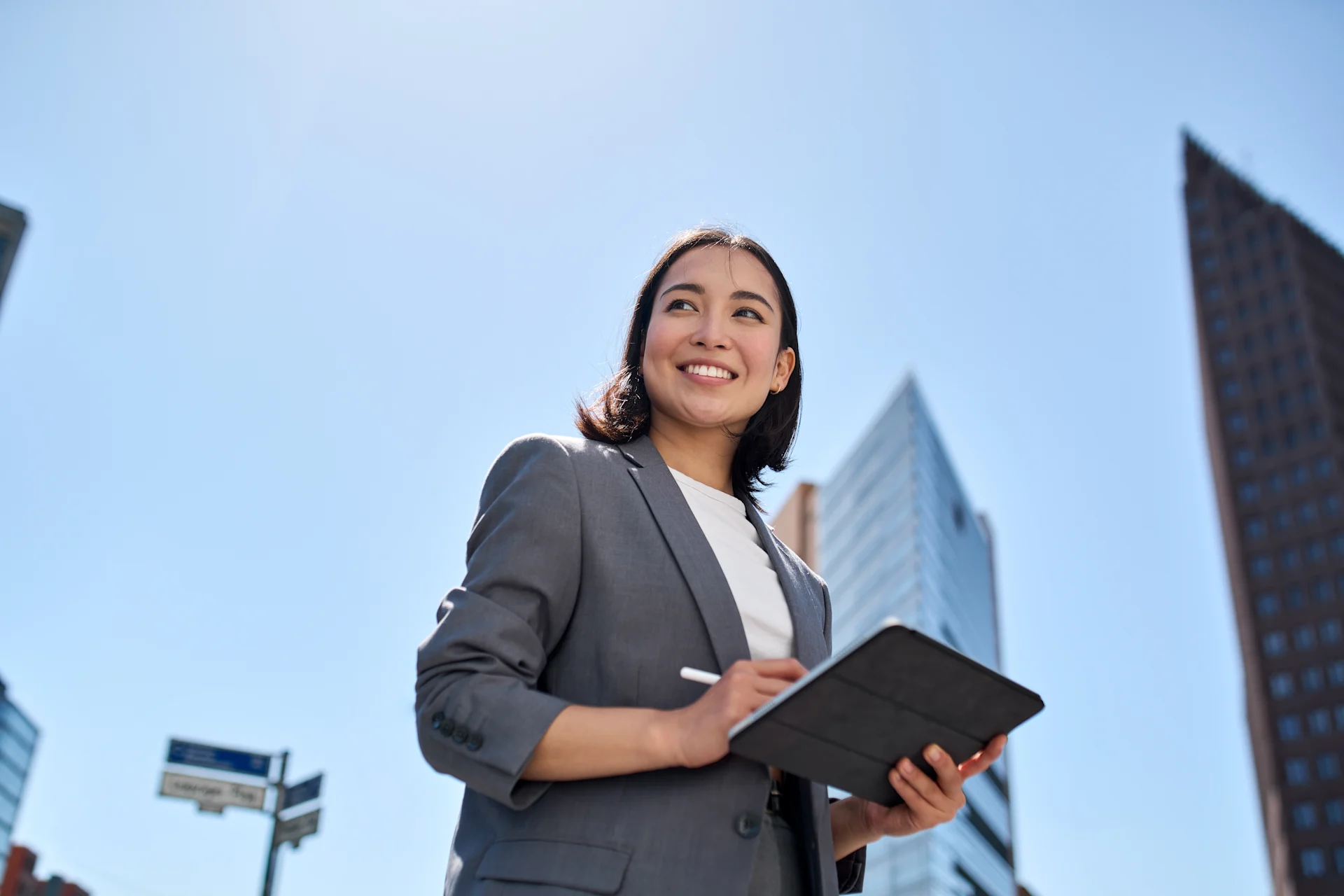 Female executive standing looking at an iPad