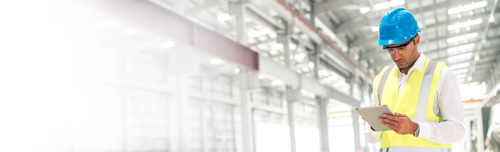 Male construction worker looking down at an iPad1200x801