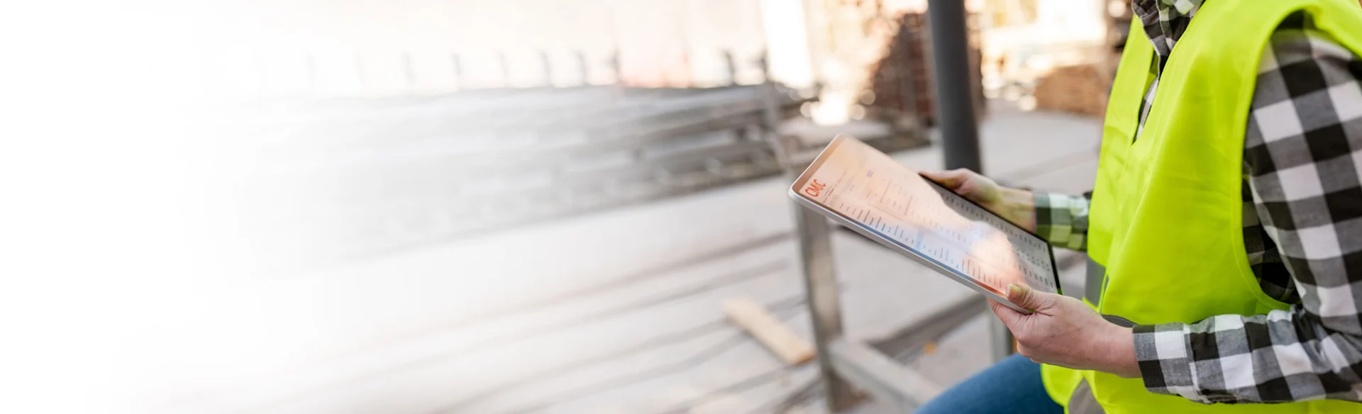 Construction worker looking at an iPad