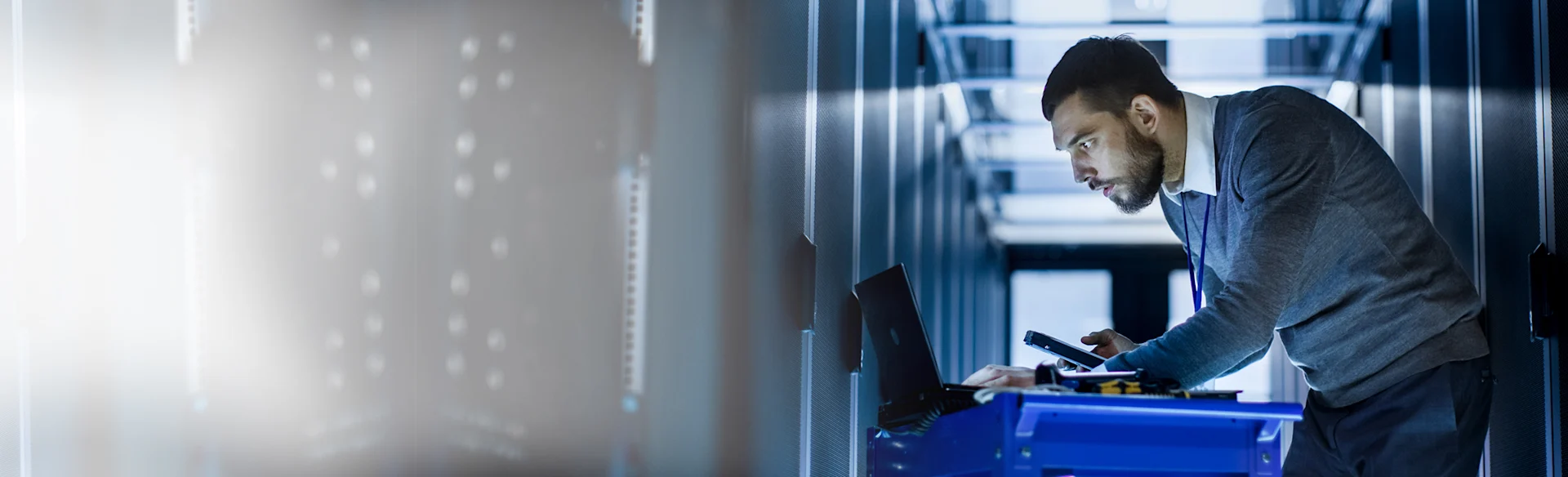 Man-Indoors-BlueDesk-Typing HEROImage