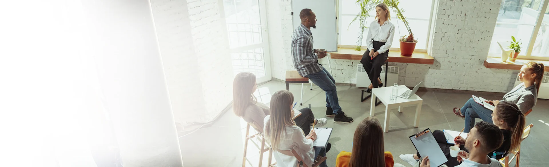 Group of employees listening to two people talk