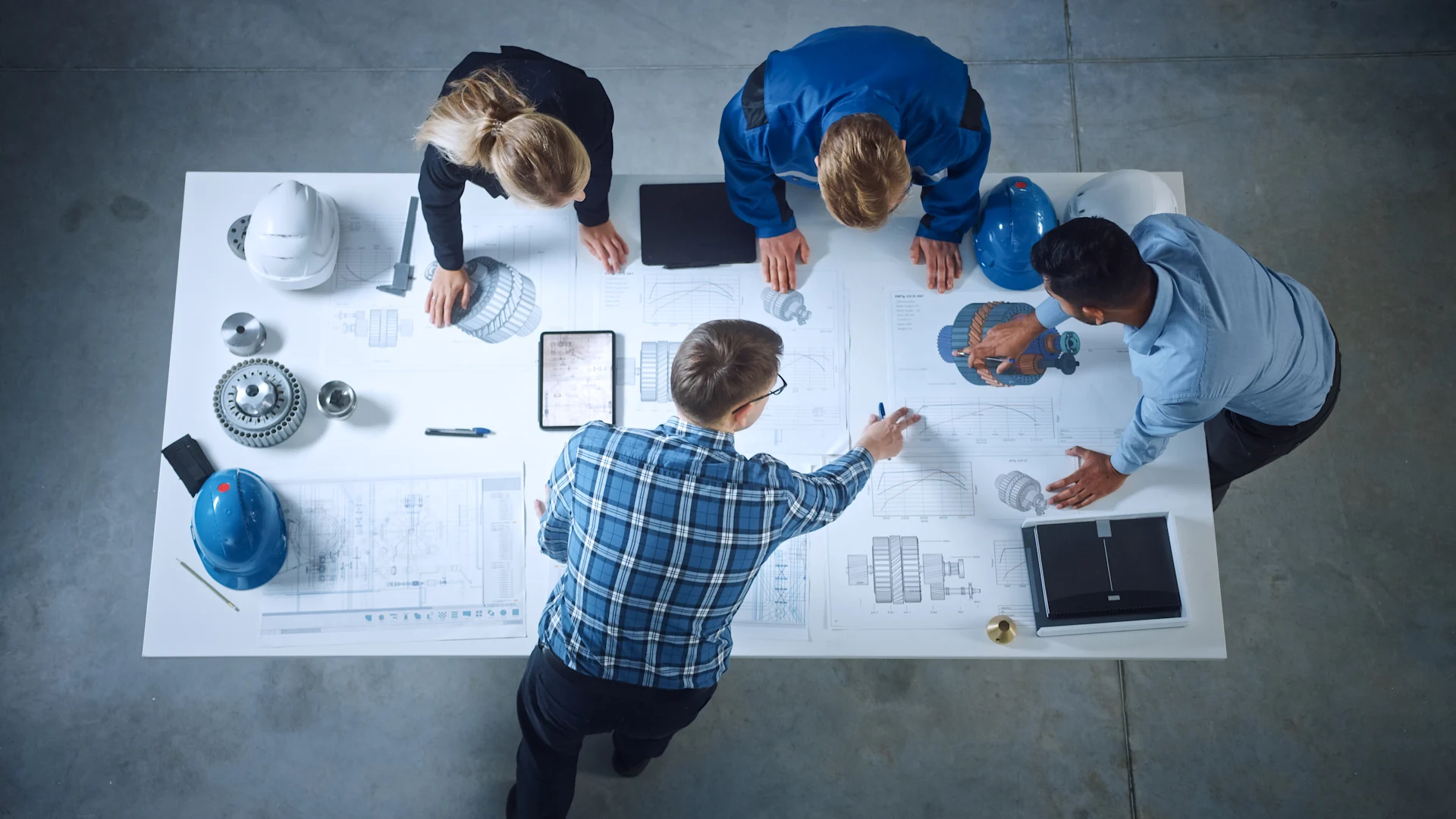 Four construction workers looking at an drawings
