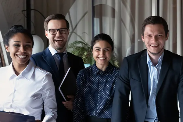 Five employees standing and smiling THUMBNAIL