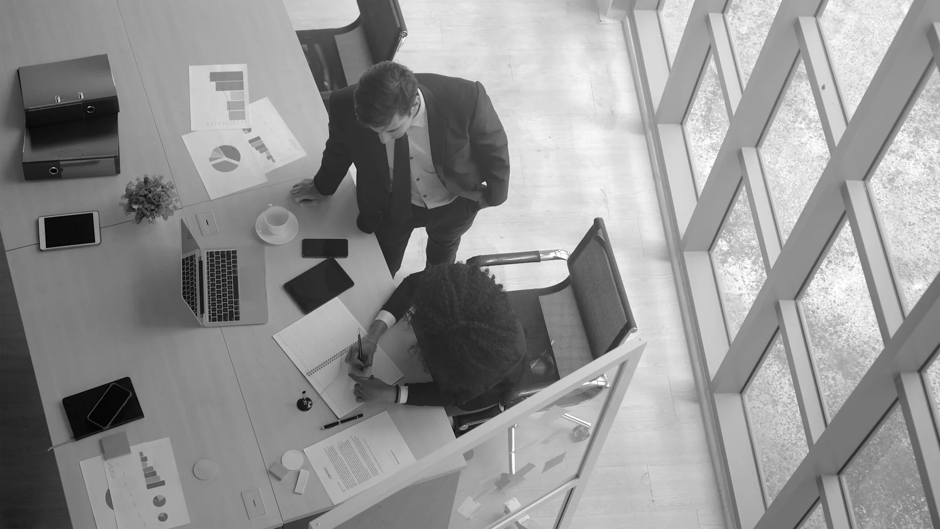 Overhead shot - 2 workers at a desk