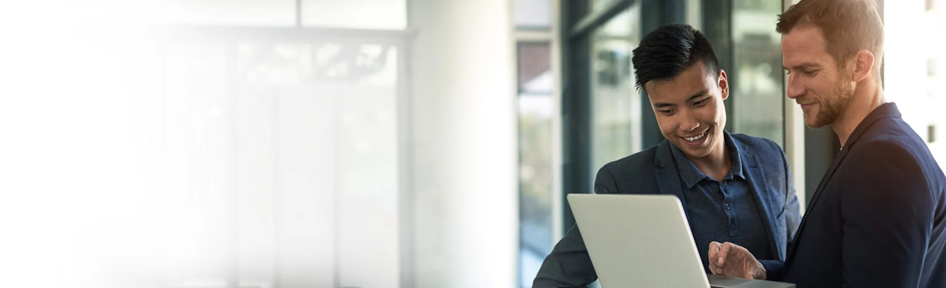 Two employees looking at a laptop