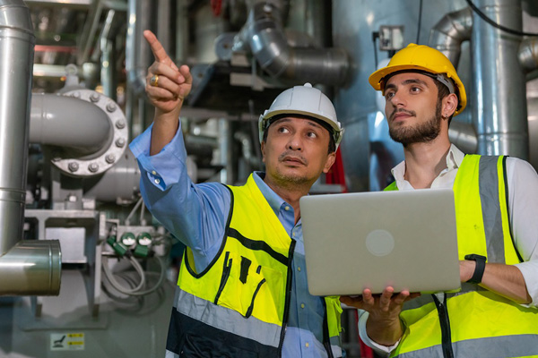 Two construction workers and one is pointing upward THUMBNAIL