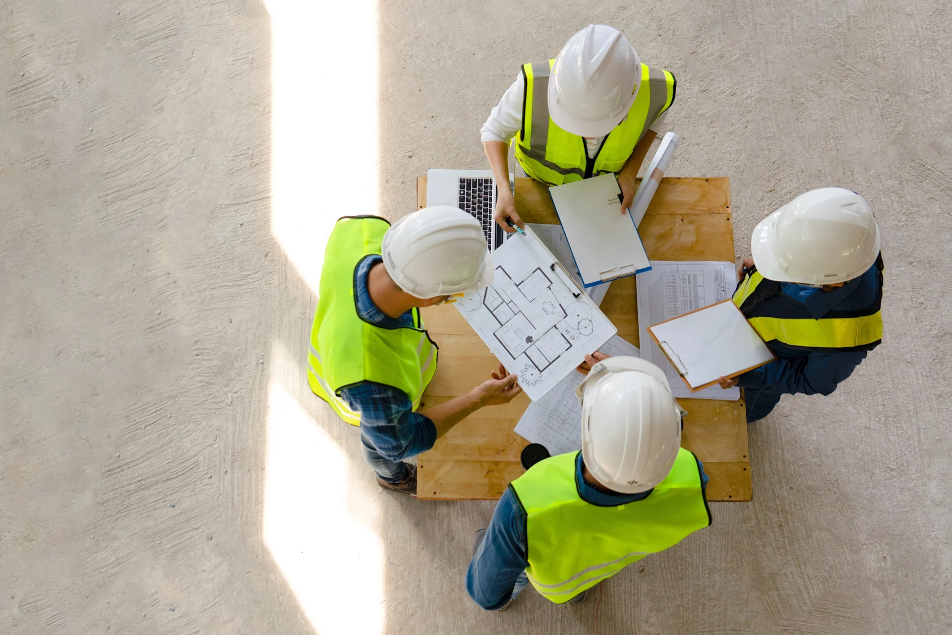 Four construction workers looking at a drawing