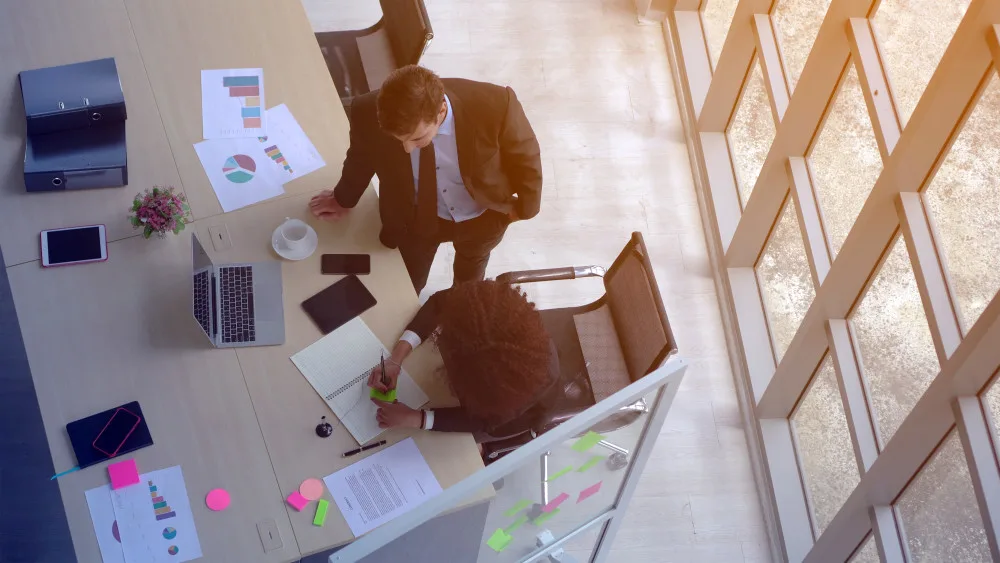 Over head shot of two executives at a desk