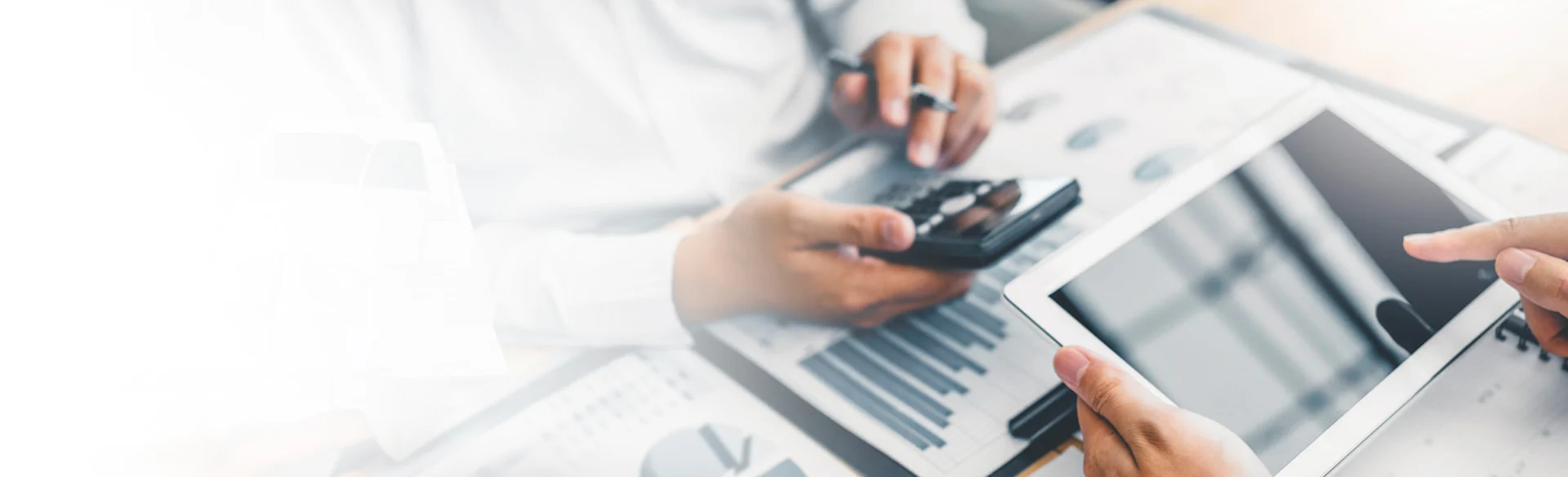 Two accountants looking at charts and an iPad 1200x800
